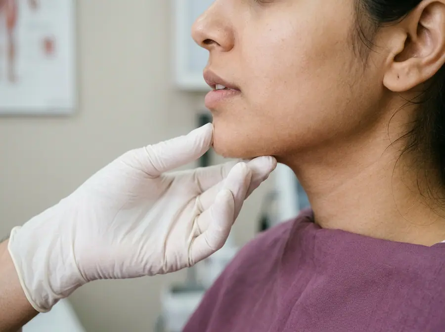 A gloved doctor's hand resting under a woman's chin during an assessment (illustrative photo)